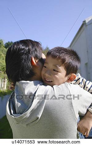 Stock Image - Father holding son. Fotosearch