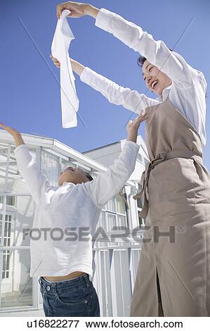 Mother and son doing laundry View Large Photo Image Stock Photo - Mother and son doing laundry. Fotosearch