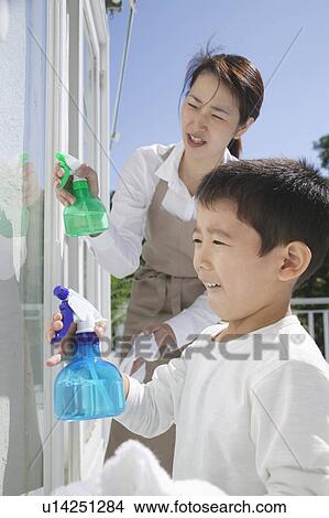Mother and son spraying window View Large Photo Image Picture - Mother and son spraying window. Fotosearch