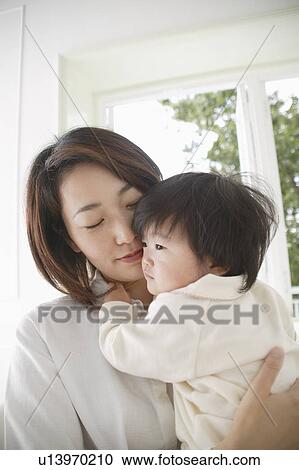 Mother holding baby girl View Large Photo Image Stock Image - Mother holding baby girl. Fotosearch