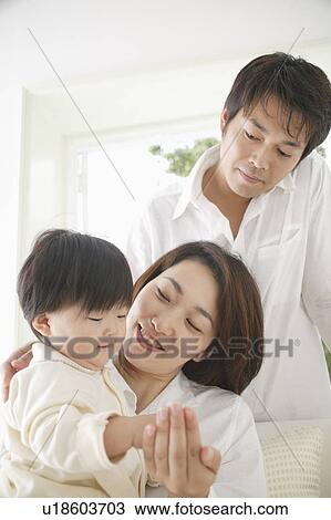 Parents and a baby girl relaxing View Large Photo Image Stock Image - Parents and a baby girl relaxing. Fotosearch
