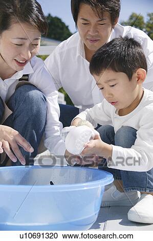 Parents and son washing shoes View Large Photo Image Stock Image - Parents and son washing shoes. Fotosearch