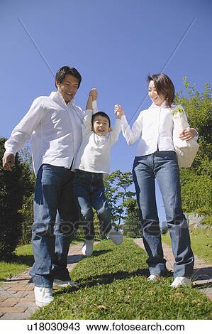 Stock Image - Parents lifting son. Fotosearch
