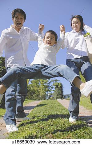 Stock Photo - Parents lifting son. Fotosearch