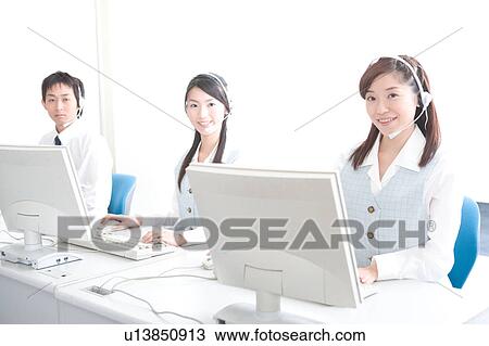 Stock Image - Three young adults wearing headsets. Fotosearch