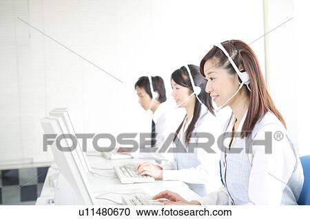 Three young adults with headsets working on computer View Large Photo Image Stock Image - Three young adults with headsets working on computer. Fotosearch