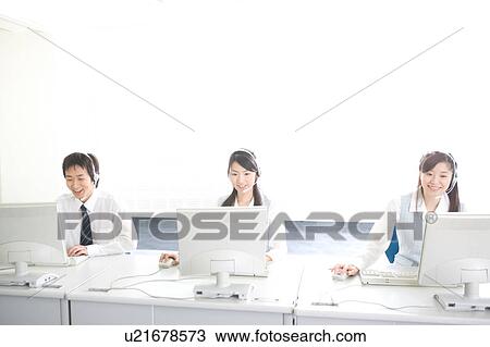 Three young adults with headsets working on computer View Large Photo Image Stock Image - Three young adults with headsets working on computer. Fotosearch