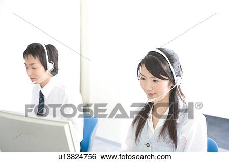 Stock Photograph - Two young adults wearing headsets. Fotosearch