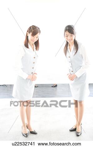 Two young women bowing View Large Photo Image Stock Image - Two young women bowing. Fotosearch