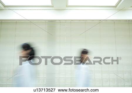 Stock Photo - Two young women passing, blurred motion. Fotosearch
