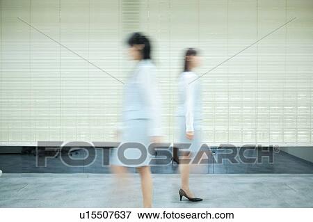 Two young women passing, blurred motion View Large Photo Image Stock Photo - Two young women passing, blurred motion. Fotosearch