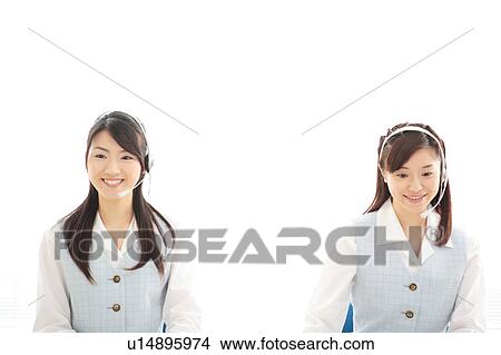 Picture - Two young women wearing headsets. Fotosearch