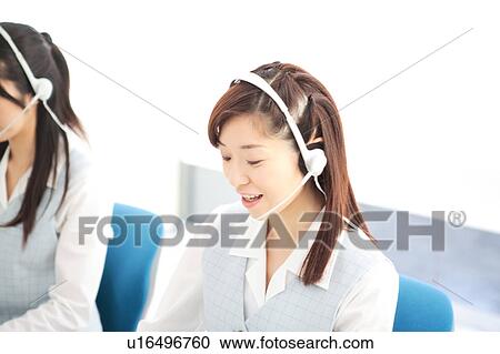 Two young women wearing headsets View Large Photo Image Stock Image - Two young women wearing headsets. Fotosearch