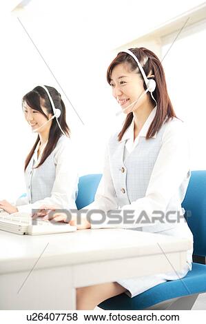 Two young women wearing headsets View Large Photo Image Stock Photo - Two young women wearing headsets. Fotosearch