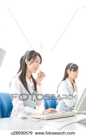Two young women wearing headsets View Large Photo Image Stock Photo - Two young women wearing headsets. Fotosearch