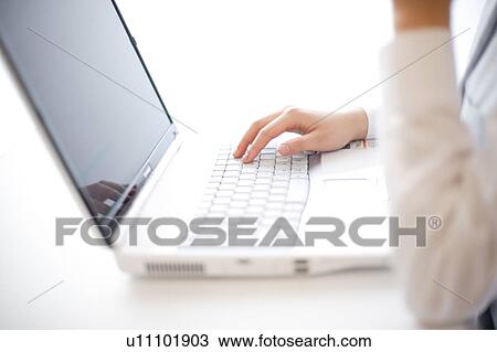 Stock Image - Woman's hand on computer keyboard. Fotosearch