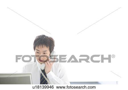 Young man talking on phone View Large Photo Image Stock Photograph - Young man talking on phone. Fotosearch