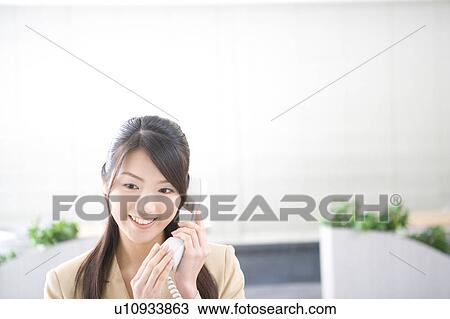 Young woman talking on phone View Large Photo Image Stock Image - Young woman talking on phone. Fotosearch