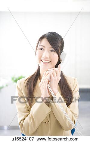 Young woman talking on phone View Large Photo Image Stock Photo - Young woman talking on phone. Fotosearch