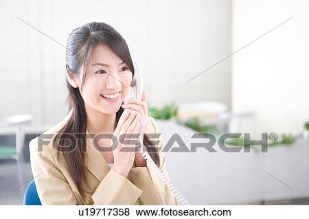 Young woman talking on phone View Large Photo Image Stock Photo - Young woman talking on phone. Fotosearch