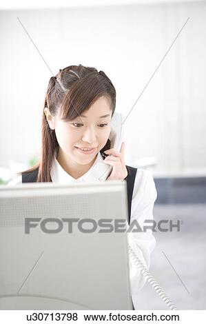 Young woman talking on phone View Large Photo Image Stock Photo - Young woman talking on phone. Fotosearch