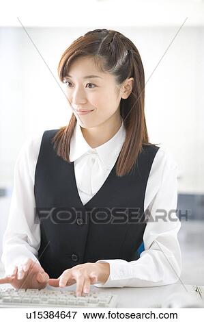 Stock Photo - Young woman typing. Fotosearch