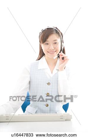 Stock Image - Young woman wearing headset. Fotosearch
