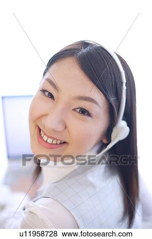 Young woman wearing headset View Large Photo Image Stock Photo - Young woman wearing headset. Fotosearch