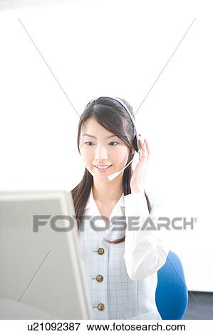 Young woman wearing headset View Large Photo Image Stock Photo - Young woman wearing headset. Fotosearch