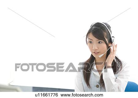 Stock Photograph - Young woman wearing headset. Fotosearch