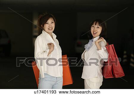 Stock Image - Two young women smiling. Fotosearch