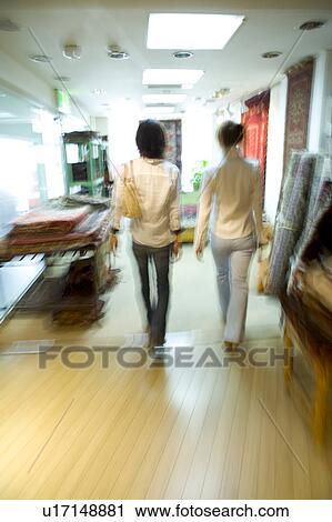 Two young women walking, blurred motion View Large Photo Image Stock Image - Two young women walking, blurred motion. Fotosearch