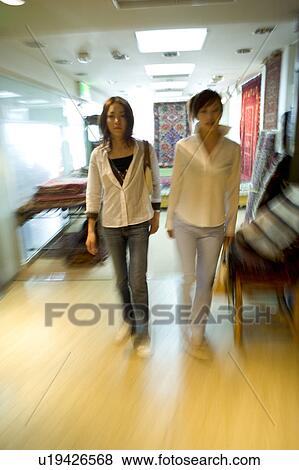 Stock Photo - Two young women walking, blurred motion. Fotosearch