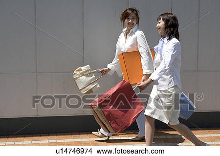 Picture - Two young women walking. Fotosearch