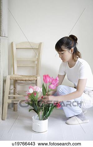 Young woman arranging flowers View Large Photo Image Stock Image - Young woman arranging flowers. Fotosearch
