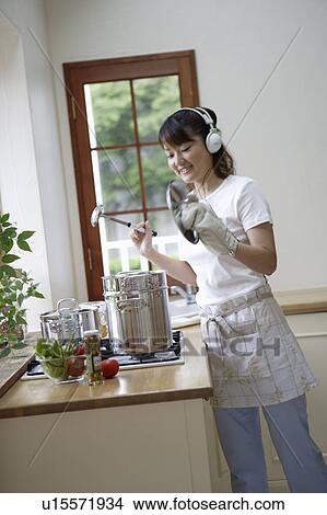 Young woman cooking View Large Photo Image Picture - Young woman cooking. Fotosearch