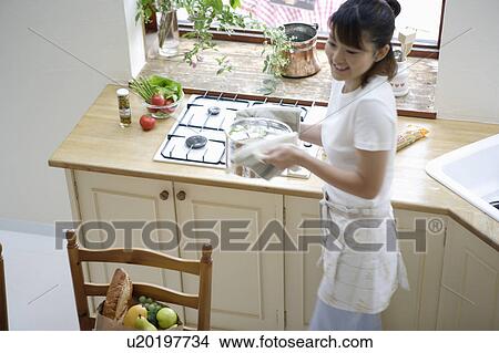 Young woman cooking View Large Photo Image Picture - Young woman cooking. Fotosearch