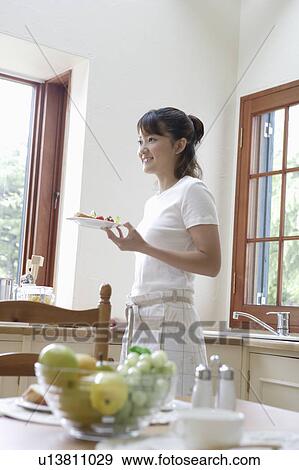 Young woman cooking View Large Photo Image Stock Photo - Young woman cooking. Fotosearch
