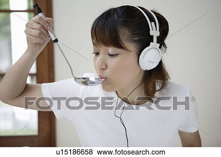 Young woman cooking View Large Photo Image Stock Photo - Young woman cooking. Fotosearch