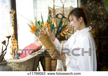 Young woman looking at bag View Large Photo Image Stock Image - Young woman looking at bag. Fotosearch