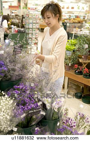 Young woman shopping at florist View Large Photo Image Stock Image - Young woman shopping at florist. Fotosearch