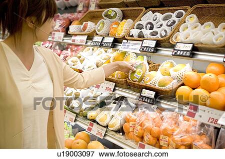 Young woman shopping at supermarket View Large Photo Image Stock Photo - Young woman shopping at supermarket. Fotosearch