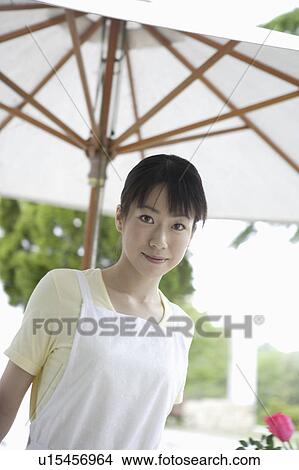 Young woman under umbrella View Large Photo Image Picture - Young woman under umbrella. Fotosearch