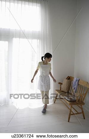 Young woman walking in room View Large Photo Image Picture - Young woman walking in room. Fotosearch