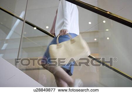 Young woman walking up stairs, blurred motion View Large Photo Image Stock Photo - Young woman walking up stairs, blurred motion. Fotosearch