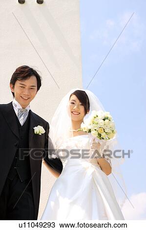 Bride and groom looking at camera View Large Photo Image Stock Image - Bride and groom looking at camera. Fotosearch