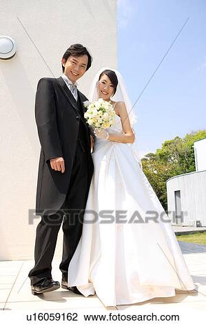 Bride and groom looking at camera View Large Photo Image Stock Image - Bride and groom looking at camera. Fotosearch