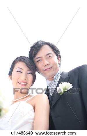 Bride and groom looking at camera View Large Photo Image Stock Photo - Bride and groom looking at camera. Fotosearch