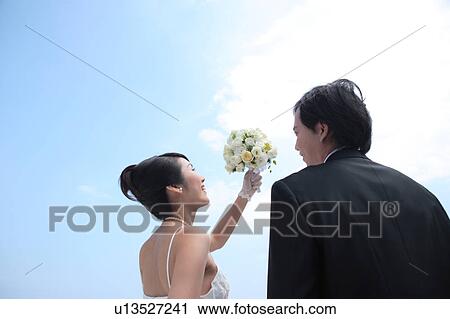 Bride and groom looking at each other View Large Photo Image Stock Image - Bride and groom looking at each other. Fotosearch