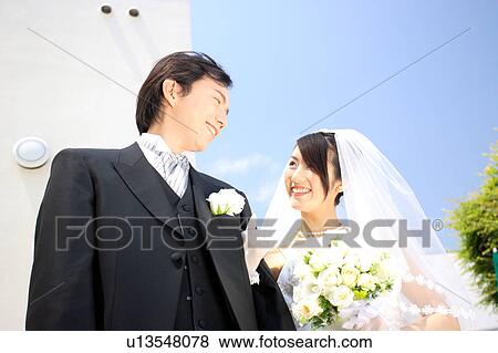 Stock Photo - Bride and groom looking at each other. Fotosearch